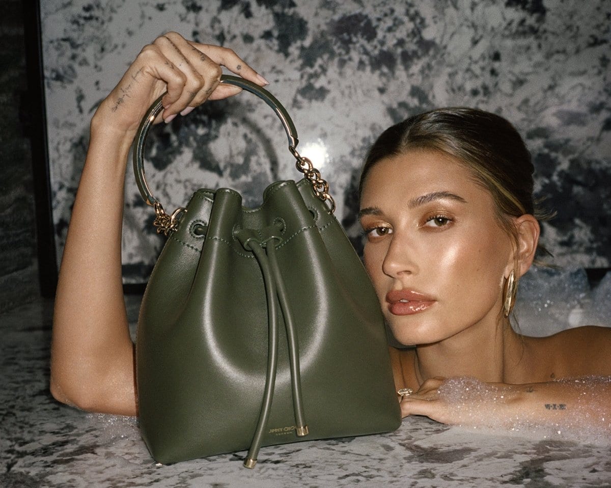 Hailey Rhode Baldwin Bieber with Jimmy Choo's Bon Bon bucket bag that's defined by a drawstring chain and metal tassels