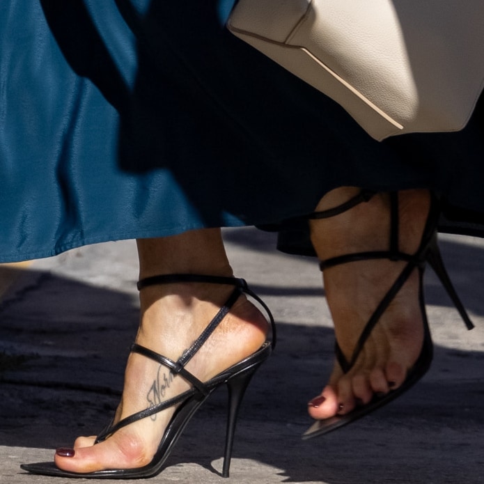 Jennifer Aniston shows off her foot tattoo in black Saint Laurent Instinct 110 heeled sandals