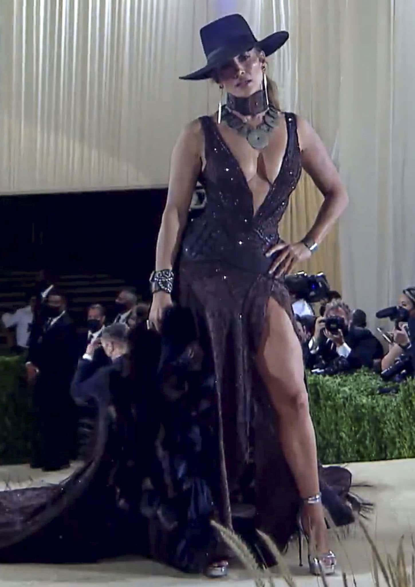 Jennifer Lopez flaunts ample cleavage and toned legs in a custom Ralph Lauren textured embellished gown with a plunging neckline and a thigh-high slit