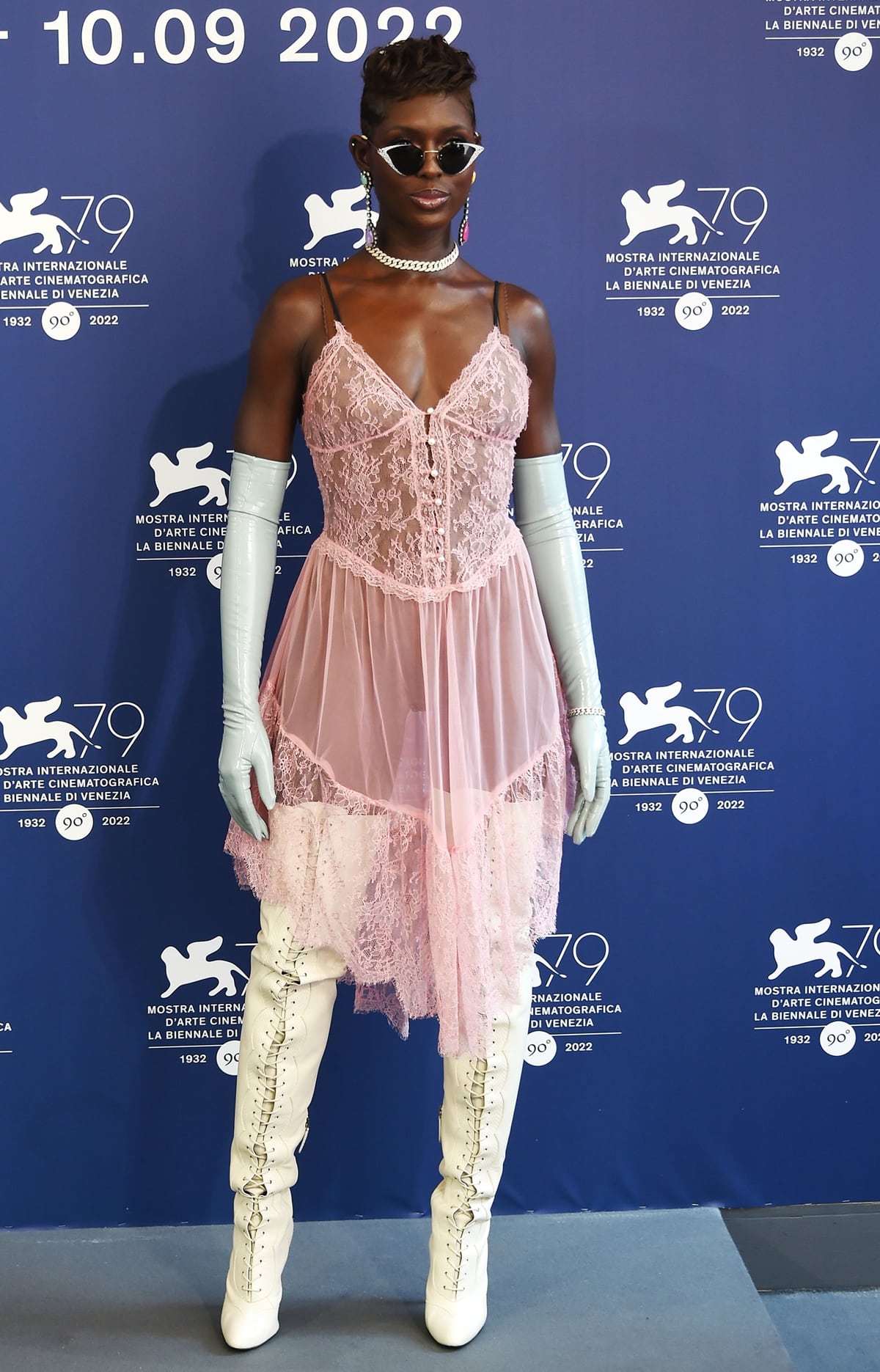Jodie Turner-Smith in a baby pink Gucci lace gown with white boots at the photocall for "White Noise" at the 79th Venice International Film Festival