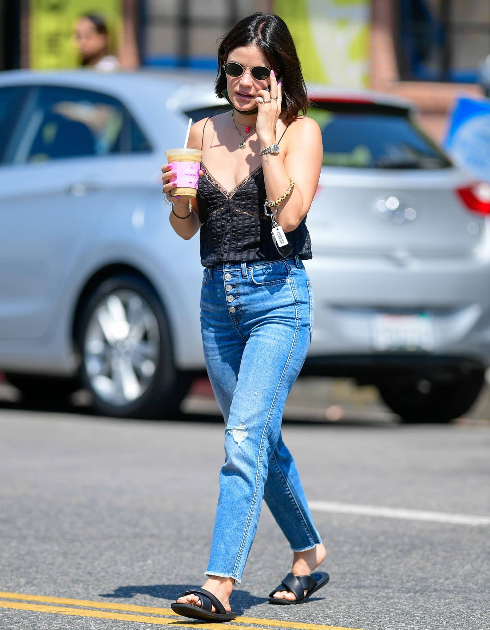 Lucy Hale flashes cleavage in Anine Bing Nadine silk camisole and 7 for All Mankind jeans