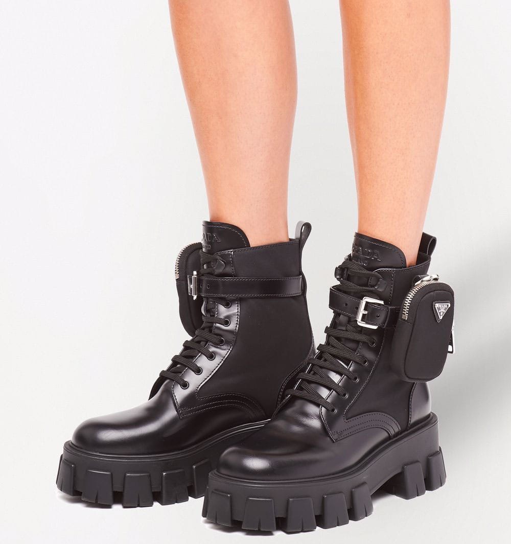 The Monolith combat boots by Prada have a belted zipped pouch and chunky lug soles