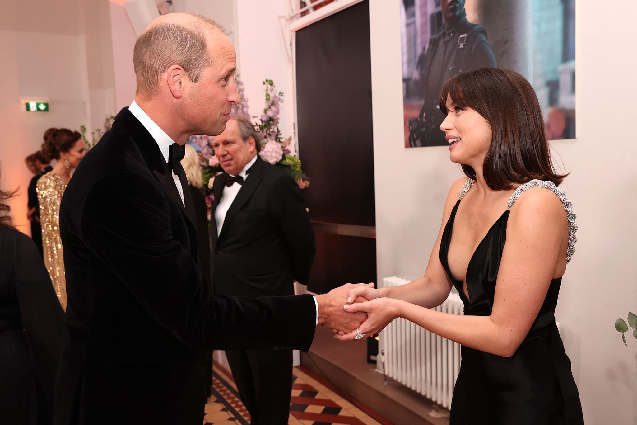 Prince William, Duke of Cambridge and Ana de Armas shake hands at the premiere of No Time to Die