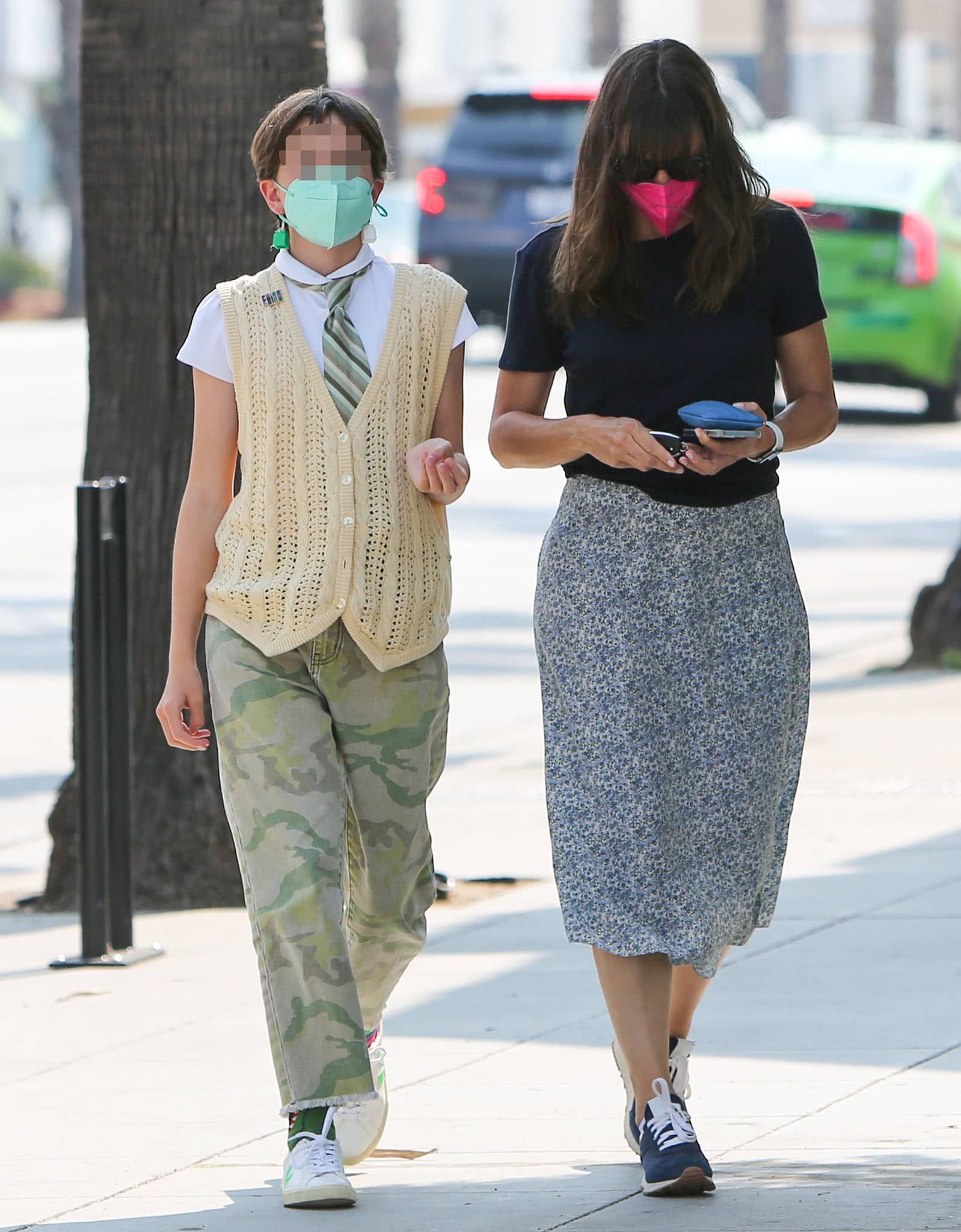 Jennifer Garner's daughter Seraphina wears a white shirt with a striped tie, yellow vest, and camouflage pants