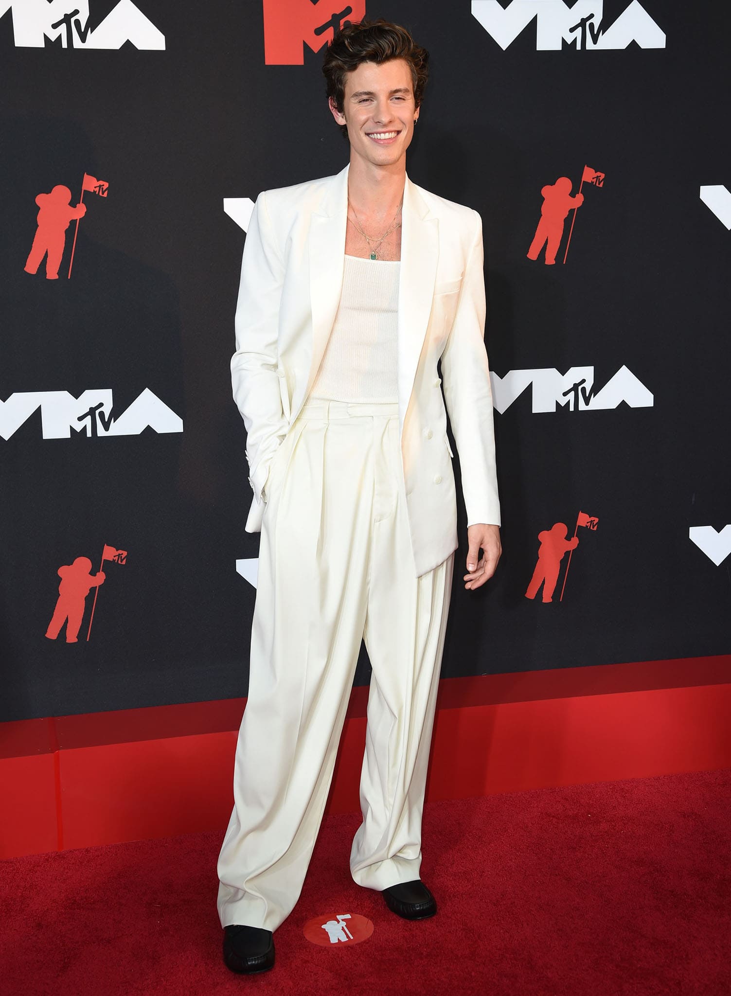 Shawn Mendes keeps it simple in a ribbed tank top with white blazer and cream pants