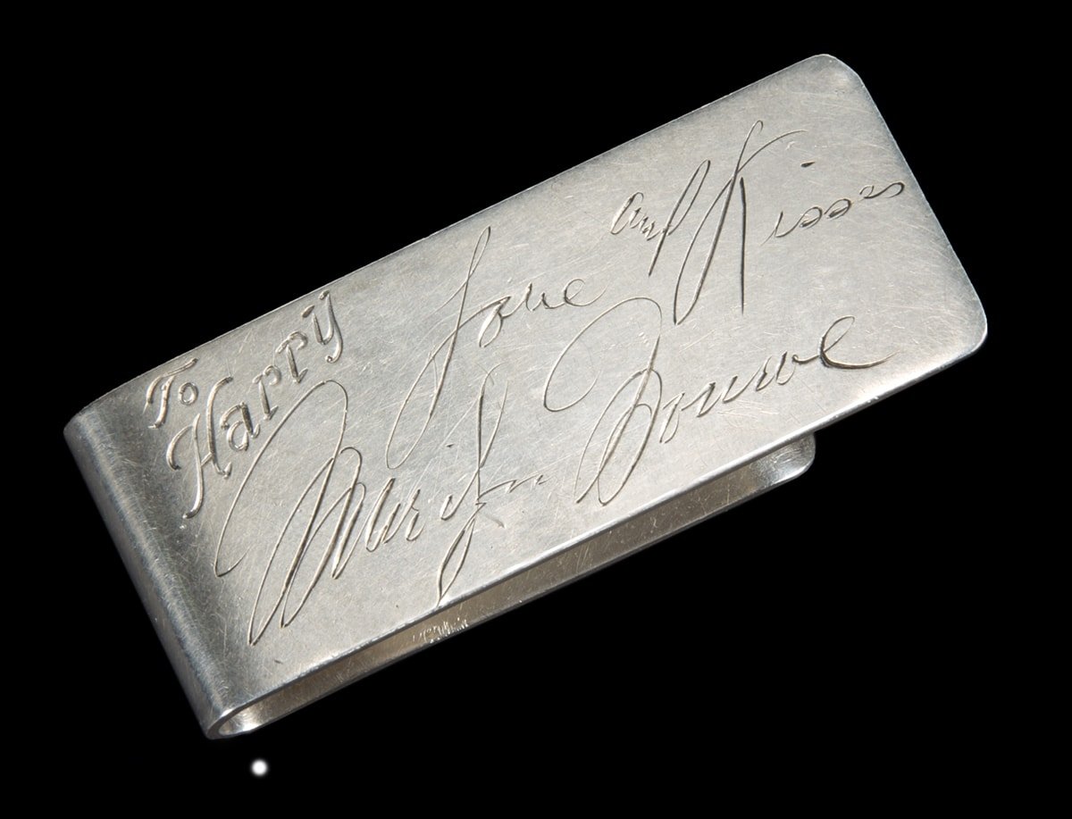 A sterling silver money clip, engraved on the front "To Harry" with the engraved signature in Monroe's hand "Love and Kisses / Marilyn Monroe