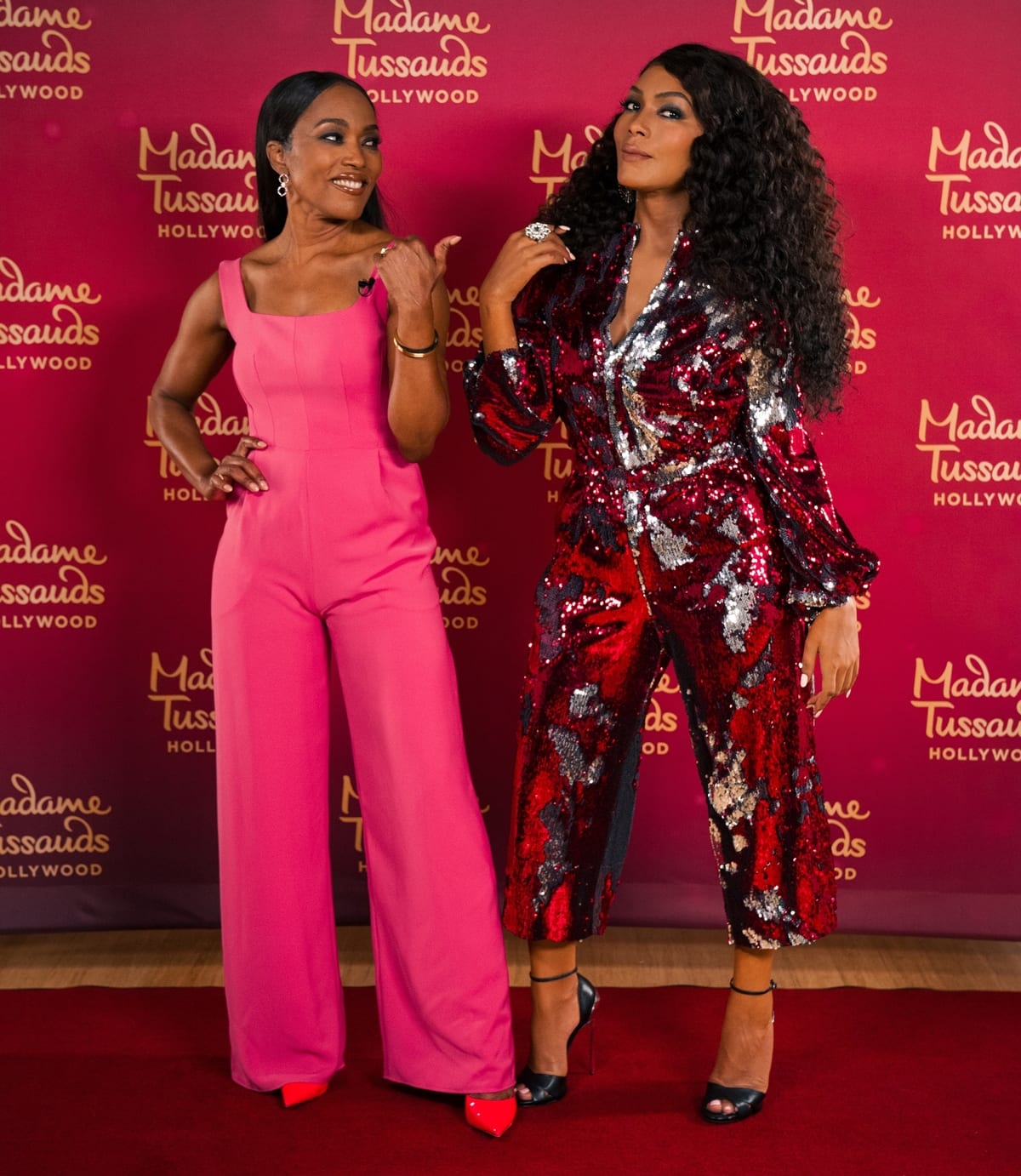 Angela Bassett's wax figure at Madame Tussauds Hollywood is wearing a sequin jumpsuit by Greta Constantine with shoes by Casadei
