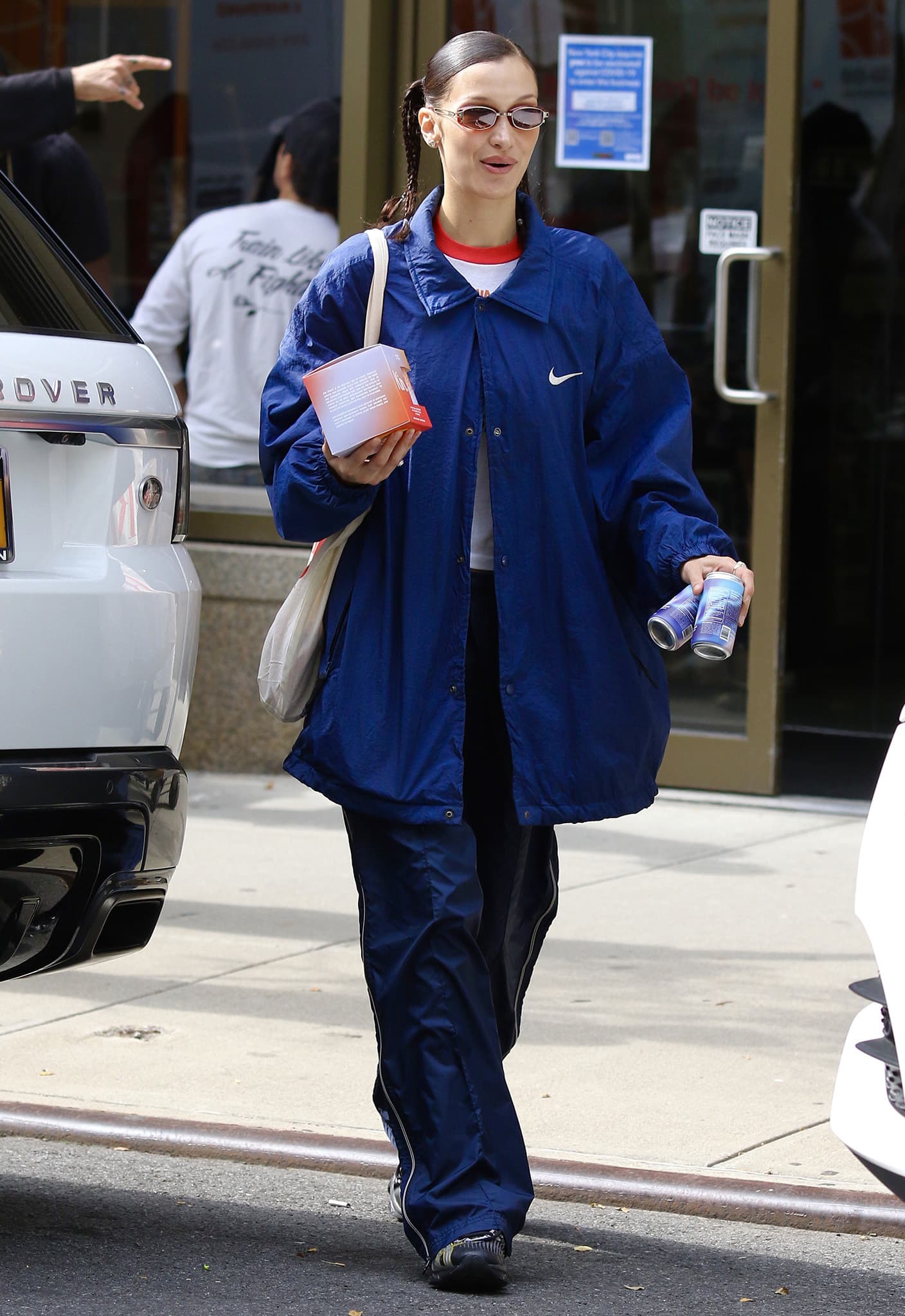 Bella Hadid shows how to wear a sporty-chic blue jacket with track pants from Nike