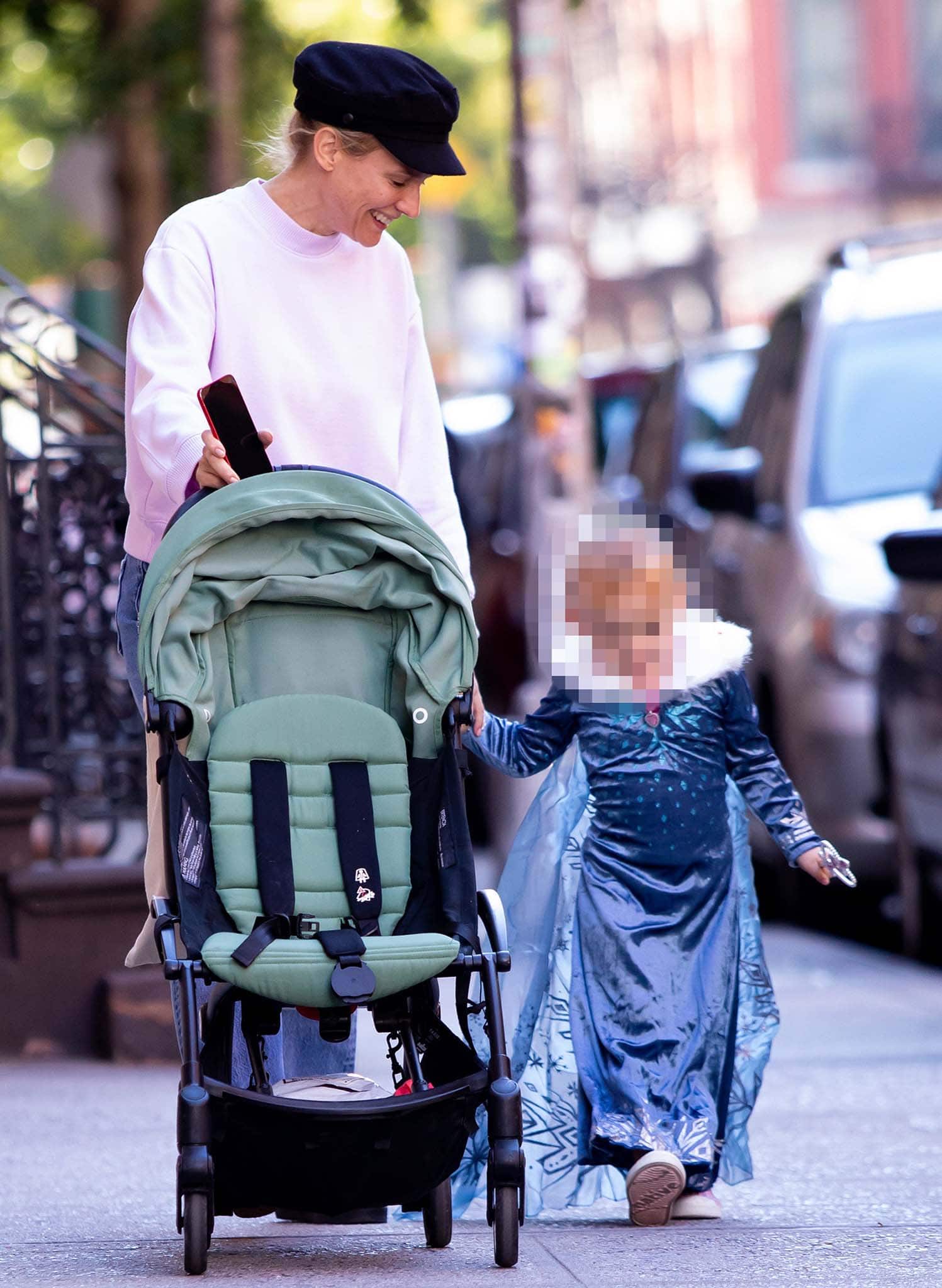 Doting mother Diane Kruger holds hands with her daughter clad in a princess costume