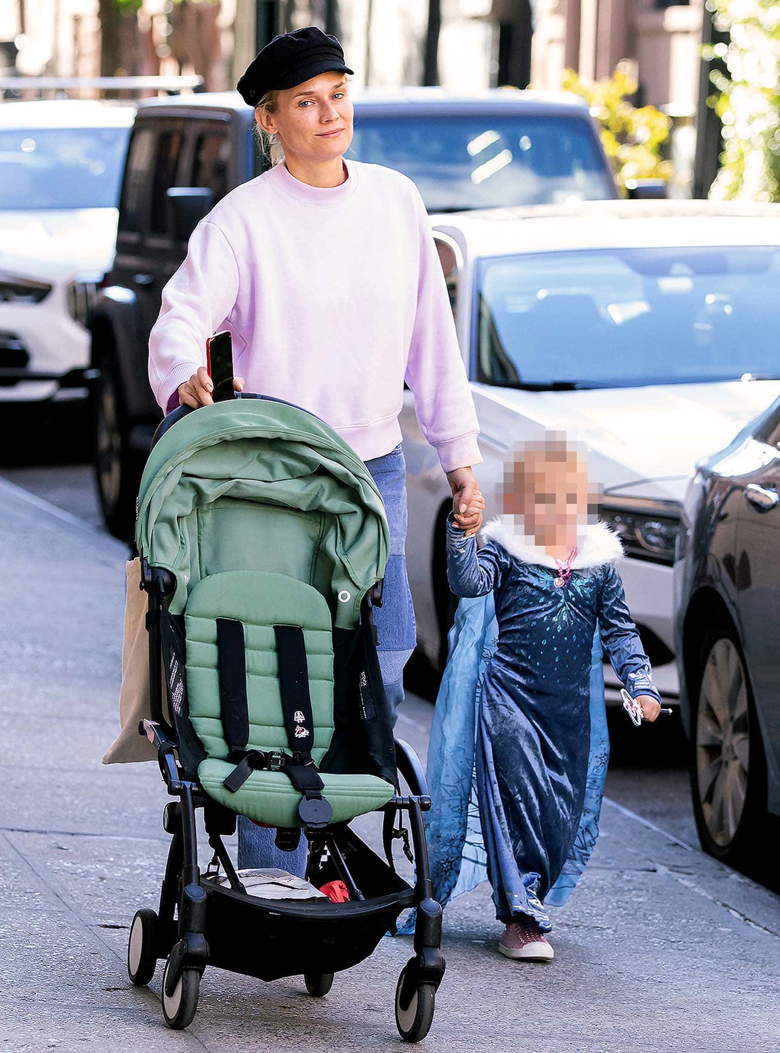 Diane Kruger opts for a casual look as she teams a pastel purple sweater with baggy jeans