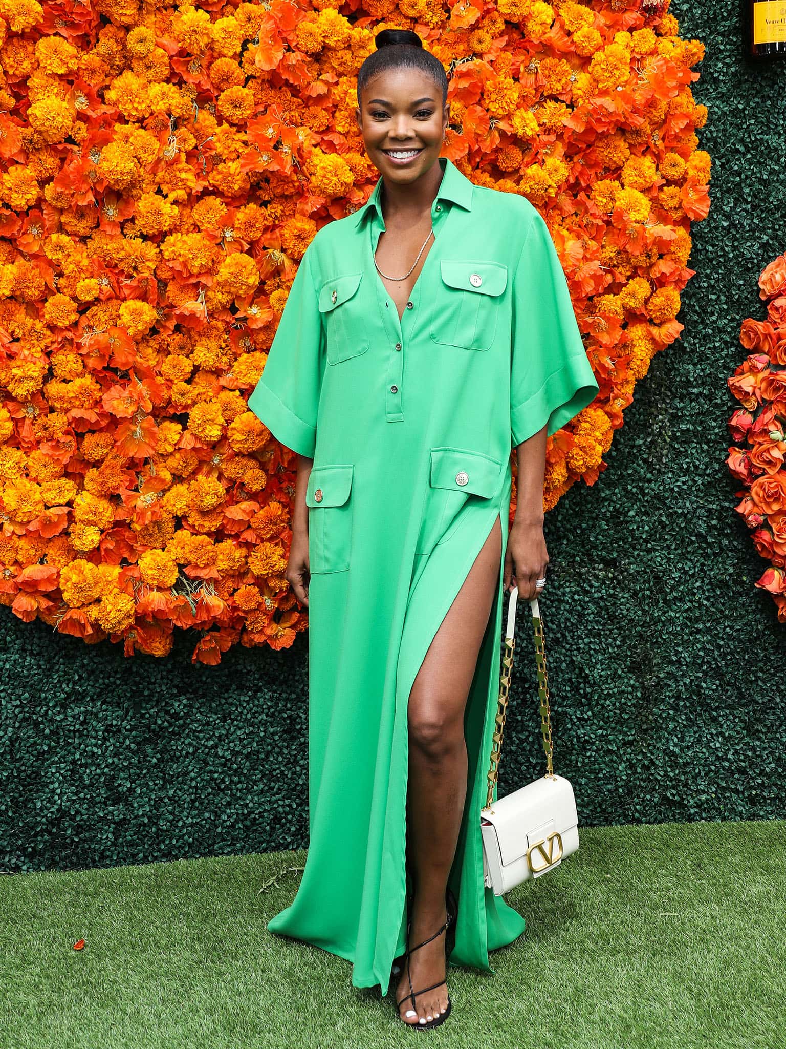 Gabrielle Union shows off her toned legs in an emerald green Elie Saab maxi shirtdress