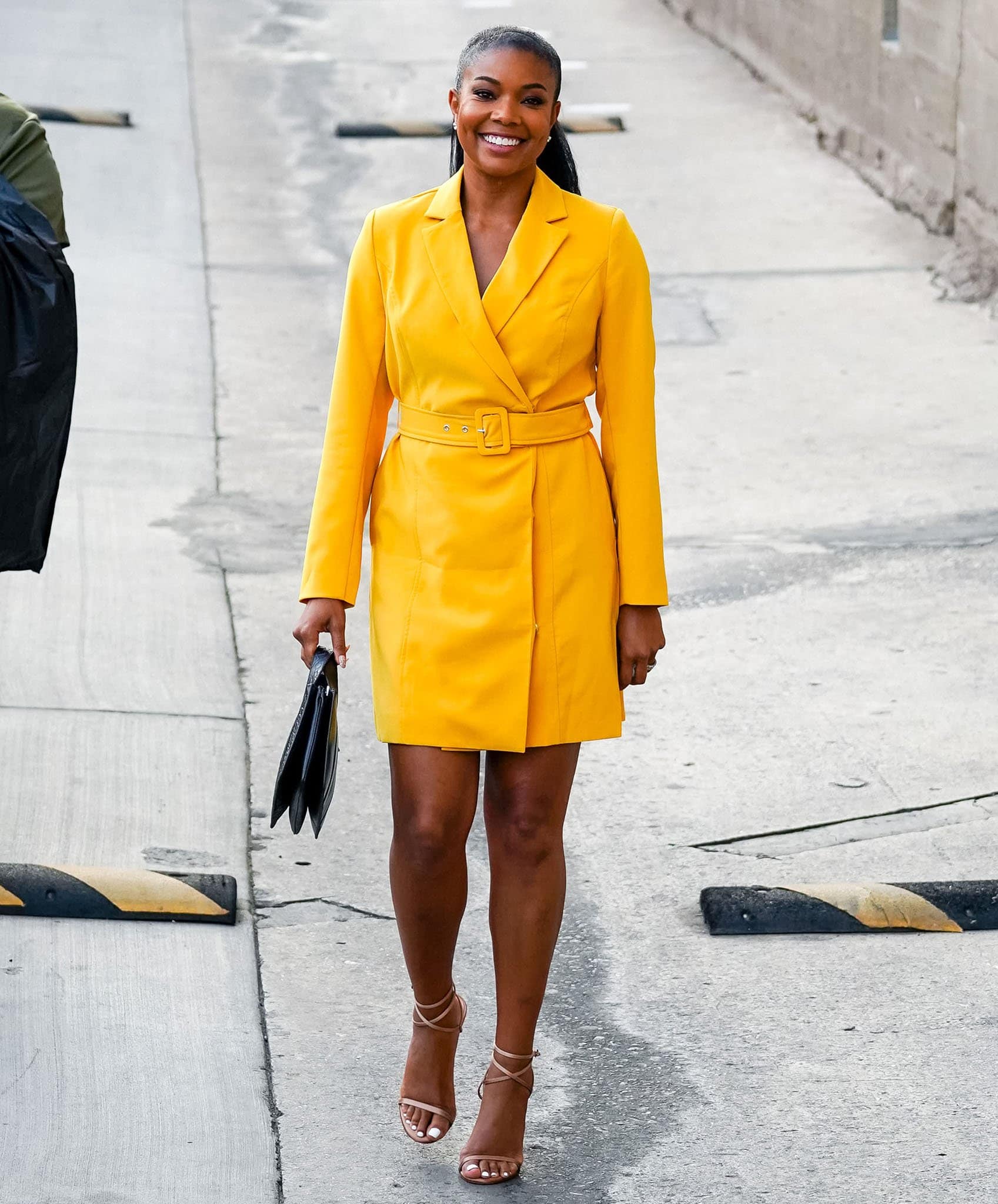 Gabrielle Union swaps her fringe dress for a yellow coat dress outside Jimmy Kimmel Live studio on September 28, 2021