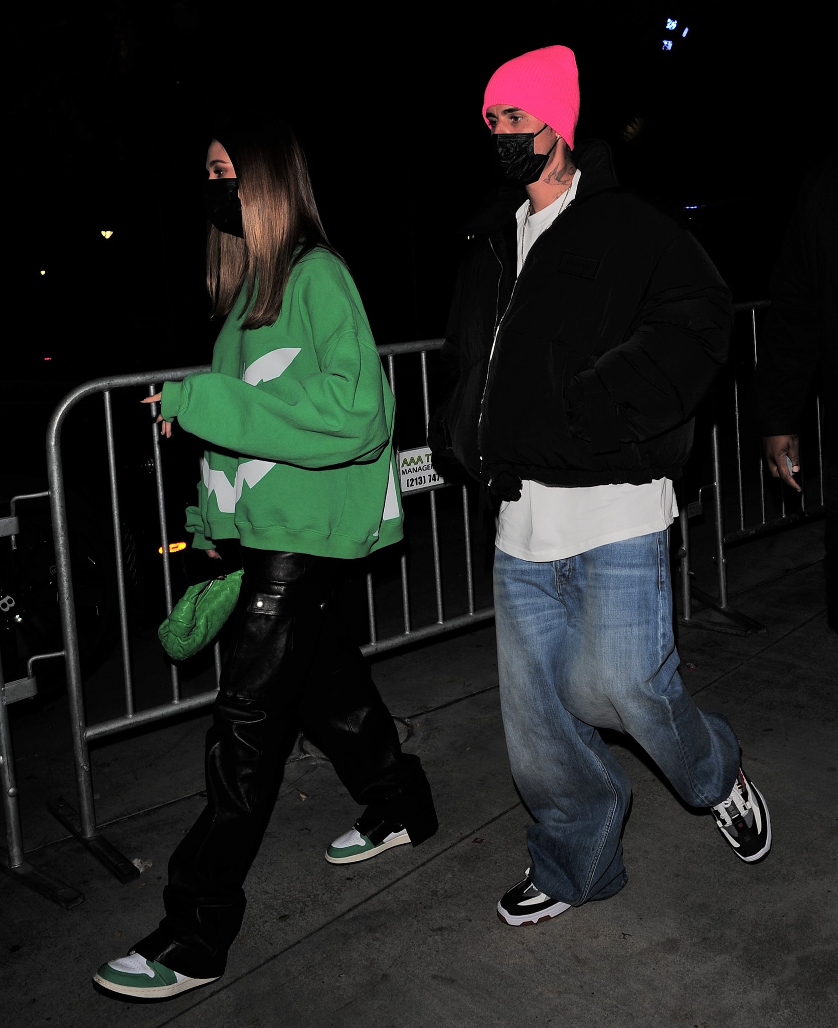 Hailey Bieber wears a green Ghost sweater from Bieber's merch with Magda Butrym leather pants on October 22, 2021