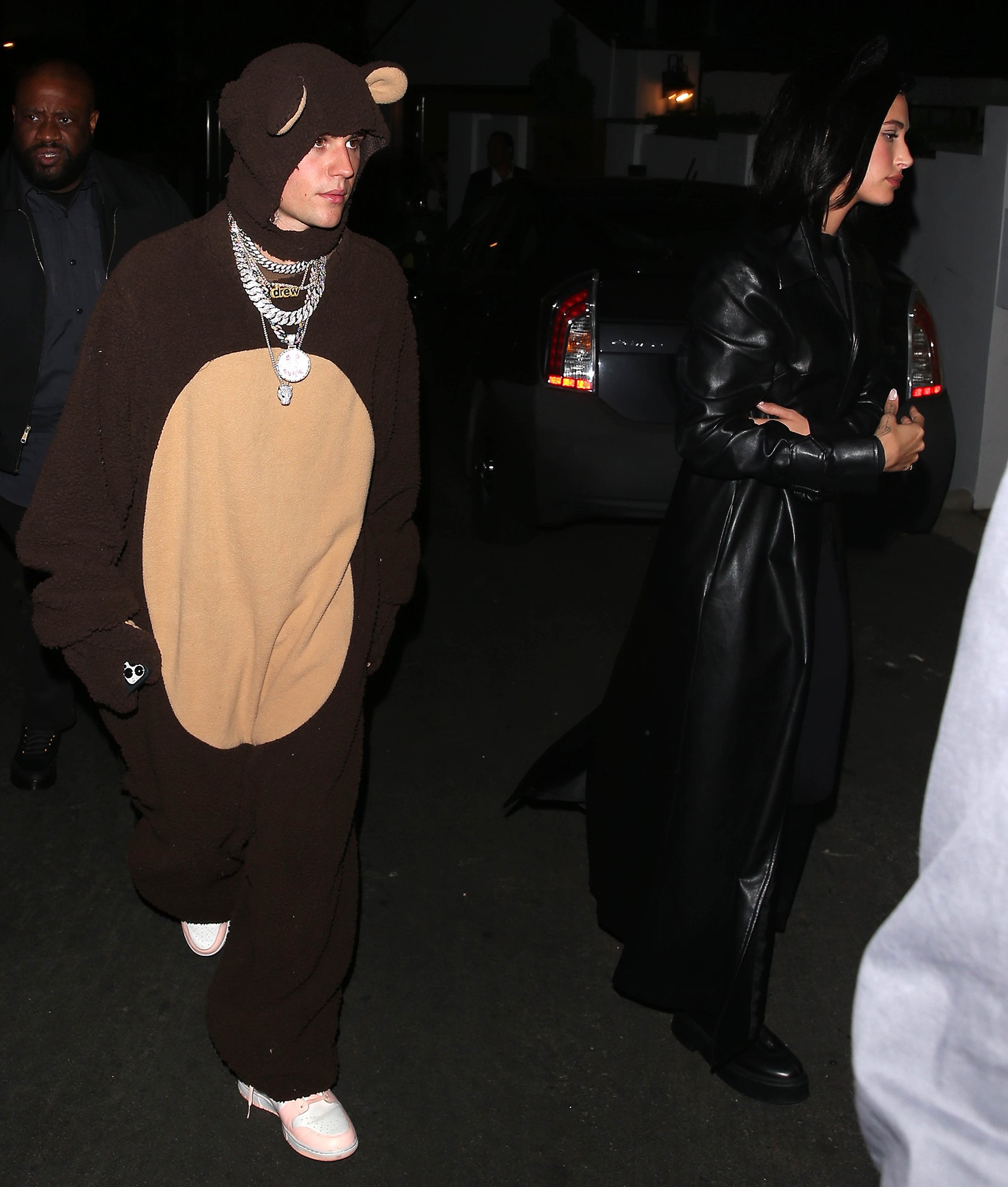 Justin Bieber dresses up as a fluffy bear while Hailey dons a leather trench coat over her catwoman suit