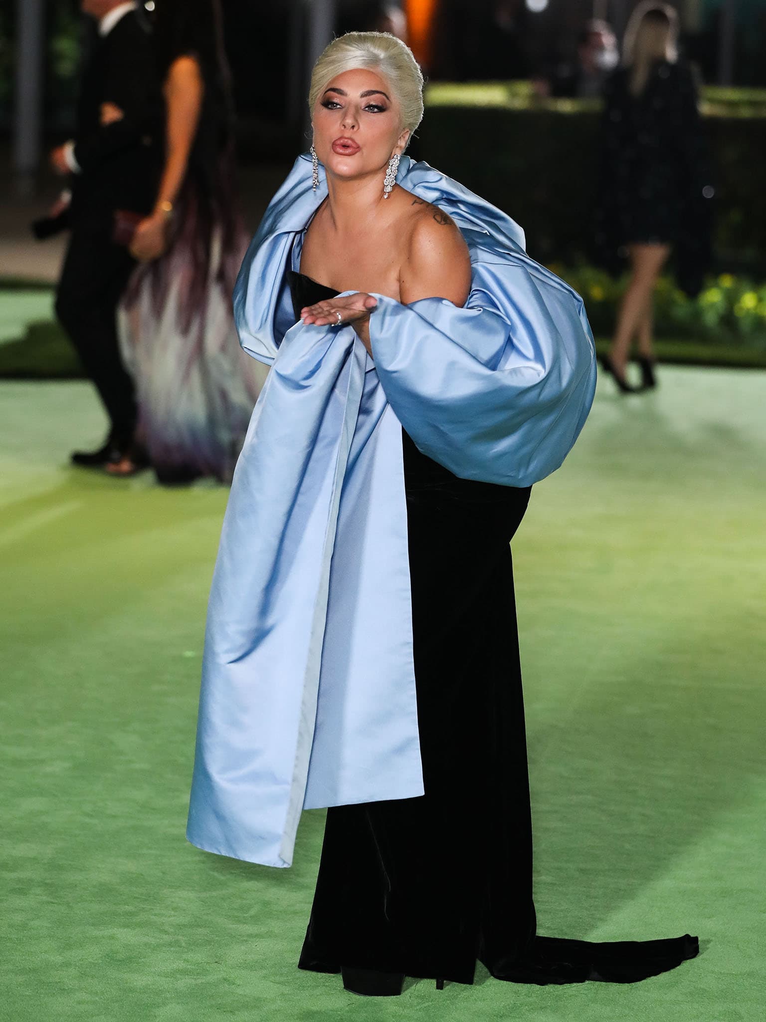 Lady Gaga exudes old Hollywood glamour in a custom Schiaparelli column gown with a powder blue stole