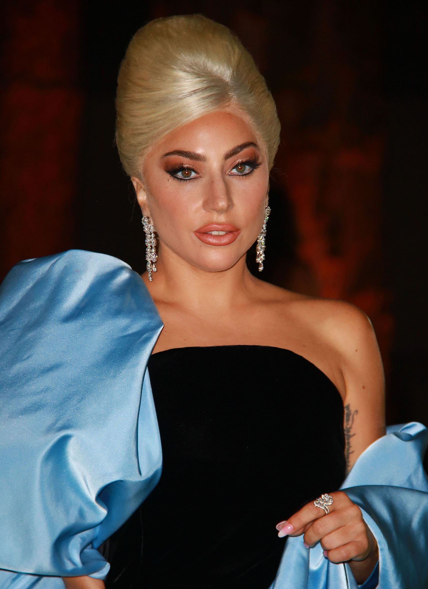 Lady Gaga continues her '60s-inspired look with a beehive hairstyle and smokey eye-makeup