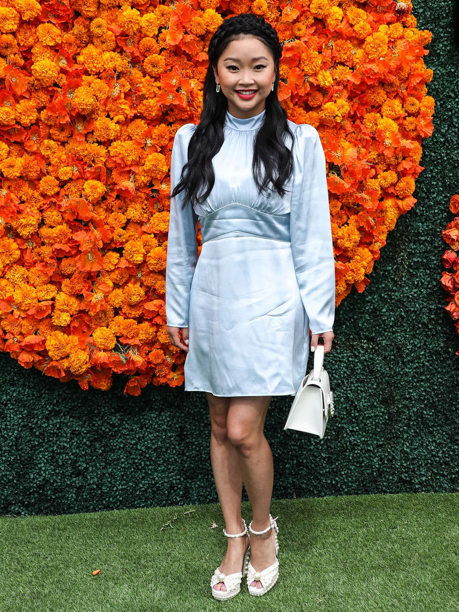 Lana Condor wears a Reformation light blue satin mini dress with puff long sleeves