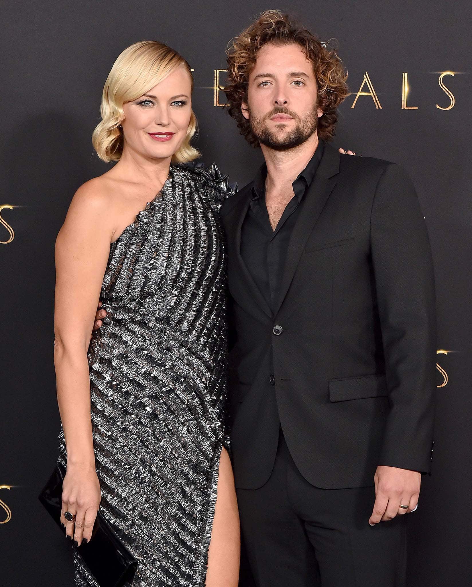 Malin Akerman opts for a sparkly futuristic dress, while her husband Jack Donnelly dons a classic all-black suit