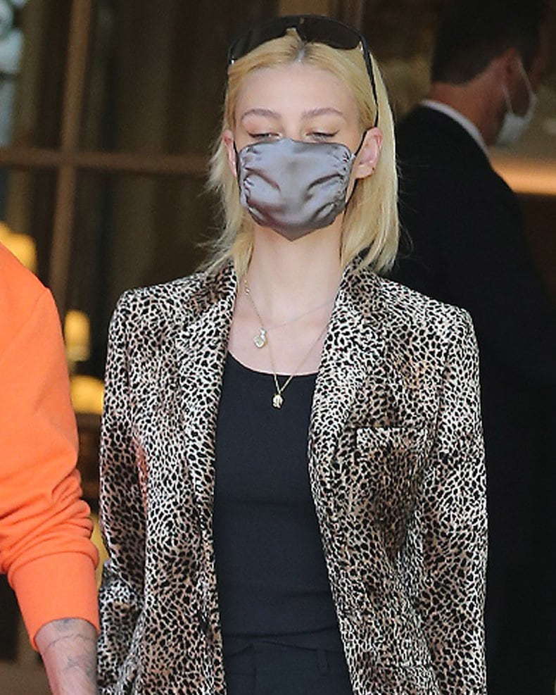 Nicola Peltz steps out with minimal makeup and wears her sunglasses over her head