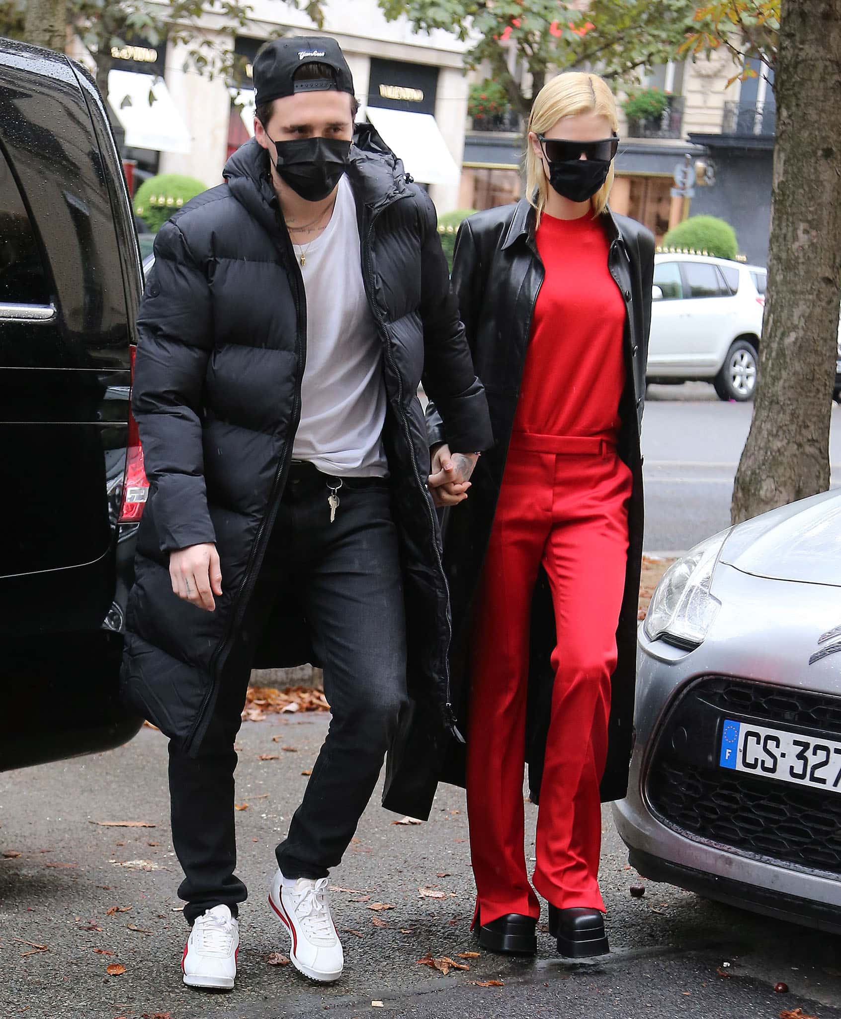 Nicola Peltz holds fiancé Brooklyn Beckham's hand while clad in coordinating red top and pants in Paris on October 1, 2021