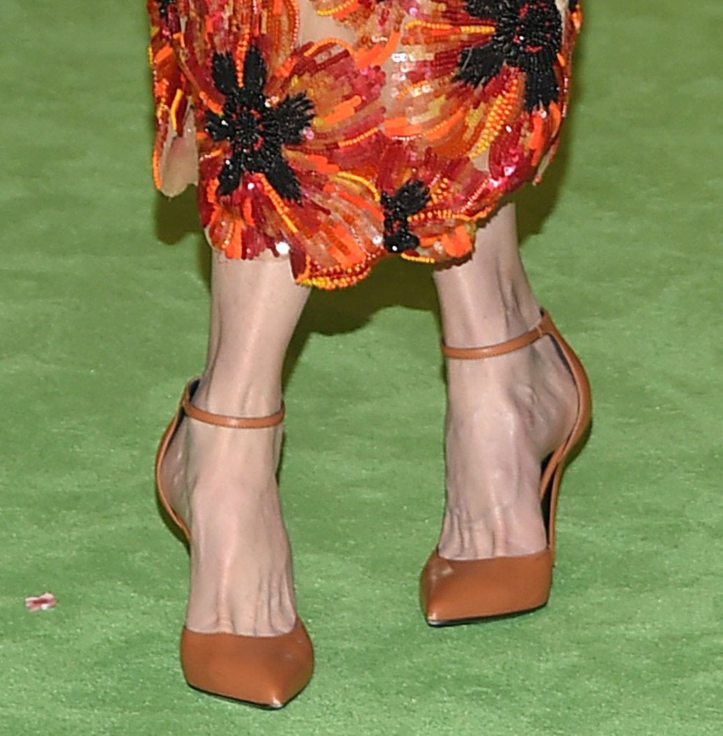 Nicole Kidman elevates her look with a sleek pair of tan pointed-toe pumps featuring delicate ankle straps and approximately 4-inch heels, perfectly complementing her vibrant Rodarte floral dress