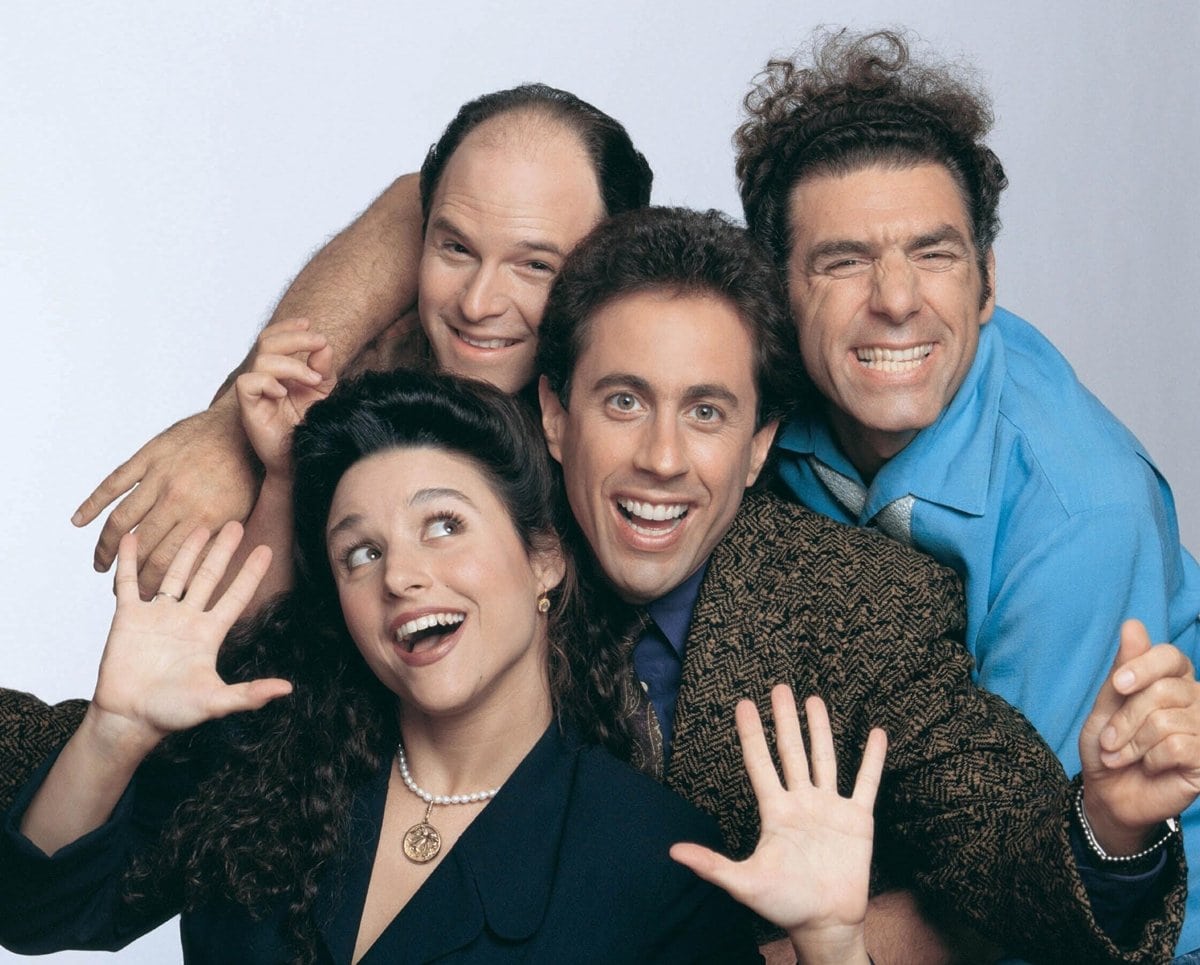 Jerry Seinfeld as a fictionalized version of himself, George Costanza (Jason Alexander), Jerry's former girlfriend Elaine Benes (Julia Louis-Dreyfus), and neighbor across the hall Cosmo Kramer (Michael Richards) in the American sitcom television series Seinfeld