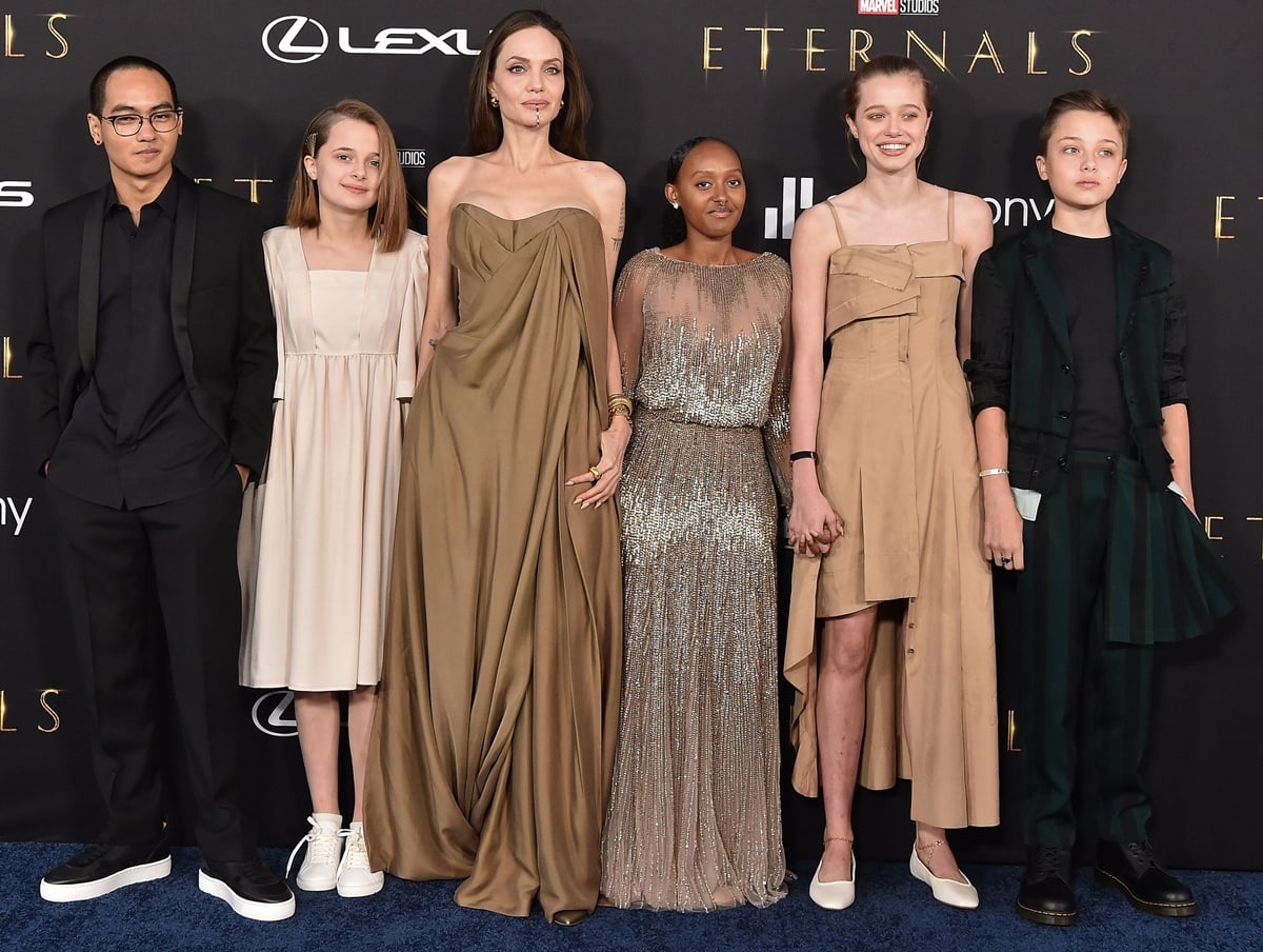 Shiloh Jolie-Pitt surprised in a dress the Los Angeles Premiere of Marvel Studios’ “Eternals” with Maddox Jolie-Pitt, Vivienne Jolie-Pitt, Angelina Jolie, Knox Jolie-Pitt, and Zahara Jolie-Pitt