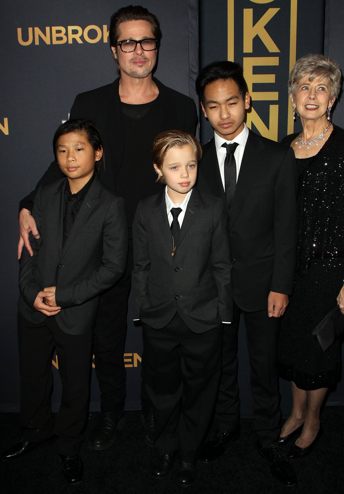 Actor Brad Pitt posing with his children Pax Jolie-Pitt, Shiloh Jolie-Pitt, and Maddox Jolie-Pitt and his mother Jane Etta Pitt at the premiere of "Unbroken"