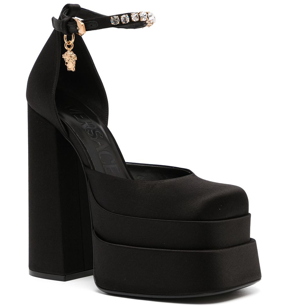 The Versace Medusa Aevitas Fall 2021 platform pumps boast a rhinestone-embellished strap, a Medusa logo charm, chunky platforms, and towering block heels