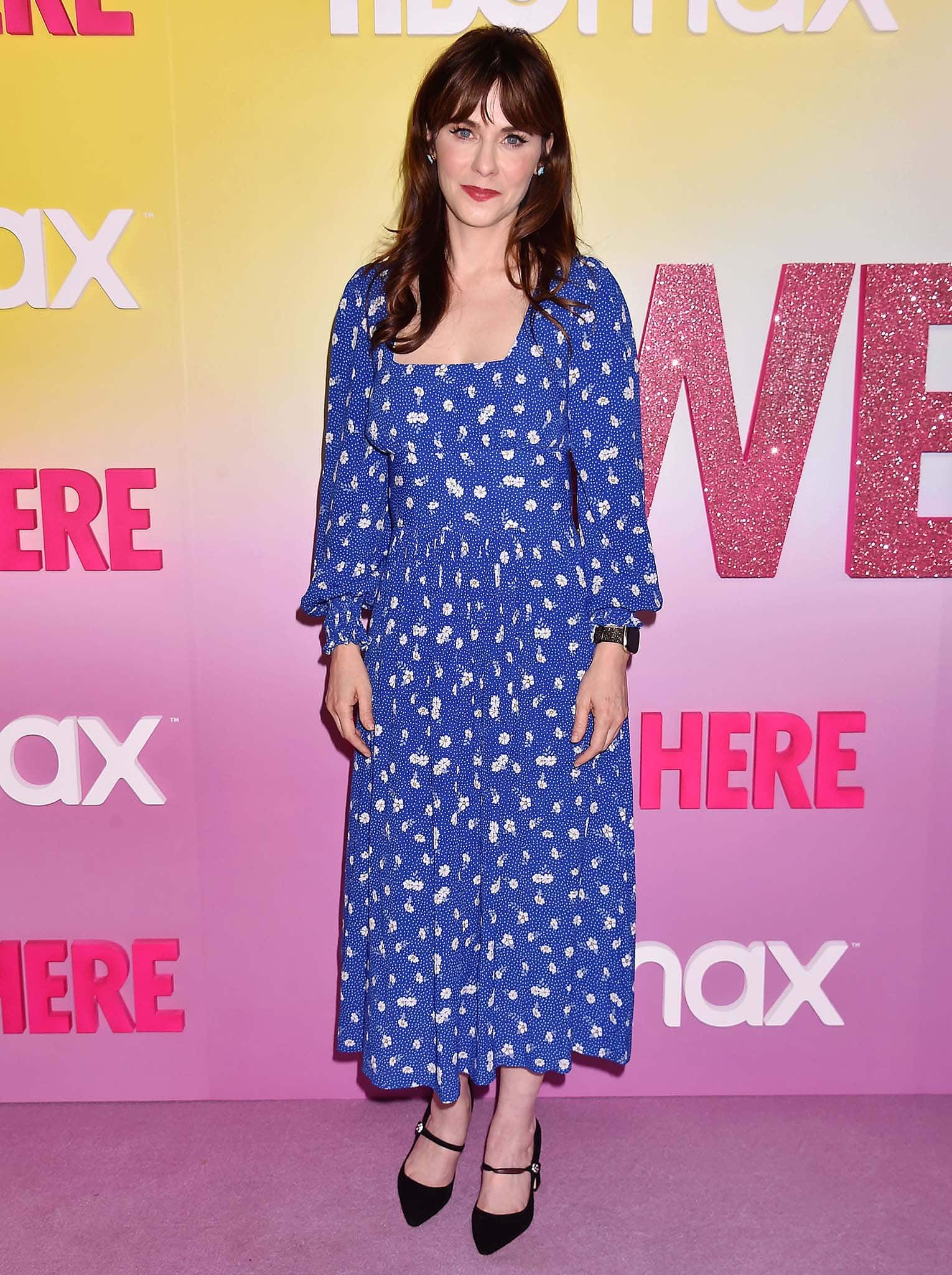 Zooey Deschanel opts for a feminine blue floral dress with a low-cut square neckline