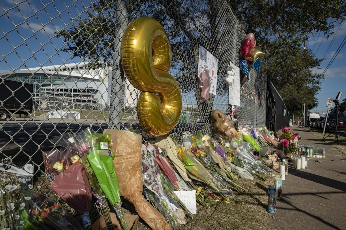 Flowers and balloons populate a memorial dedicated to the Travis Scott fans that died at Astroworld Festival