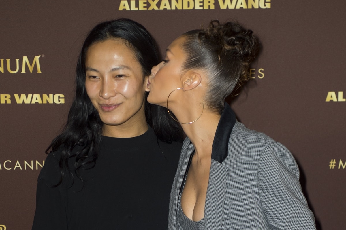 Designer Alexander Wang gets kissed by model Bella Hadid at the Magnum VIP Party