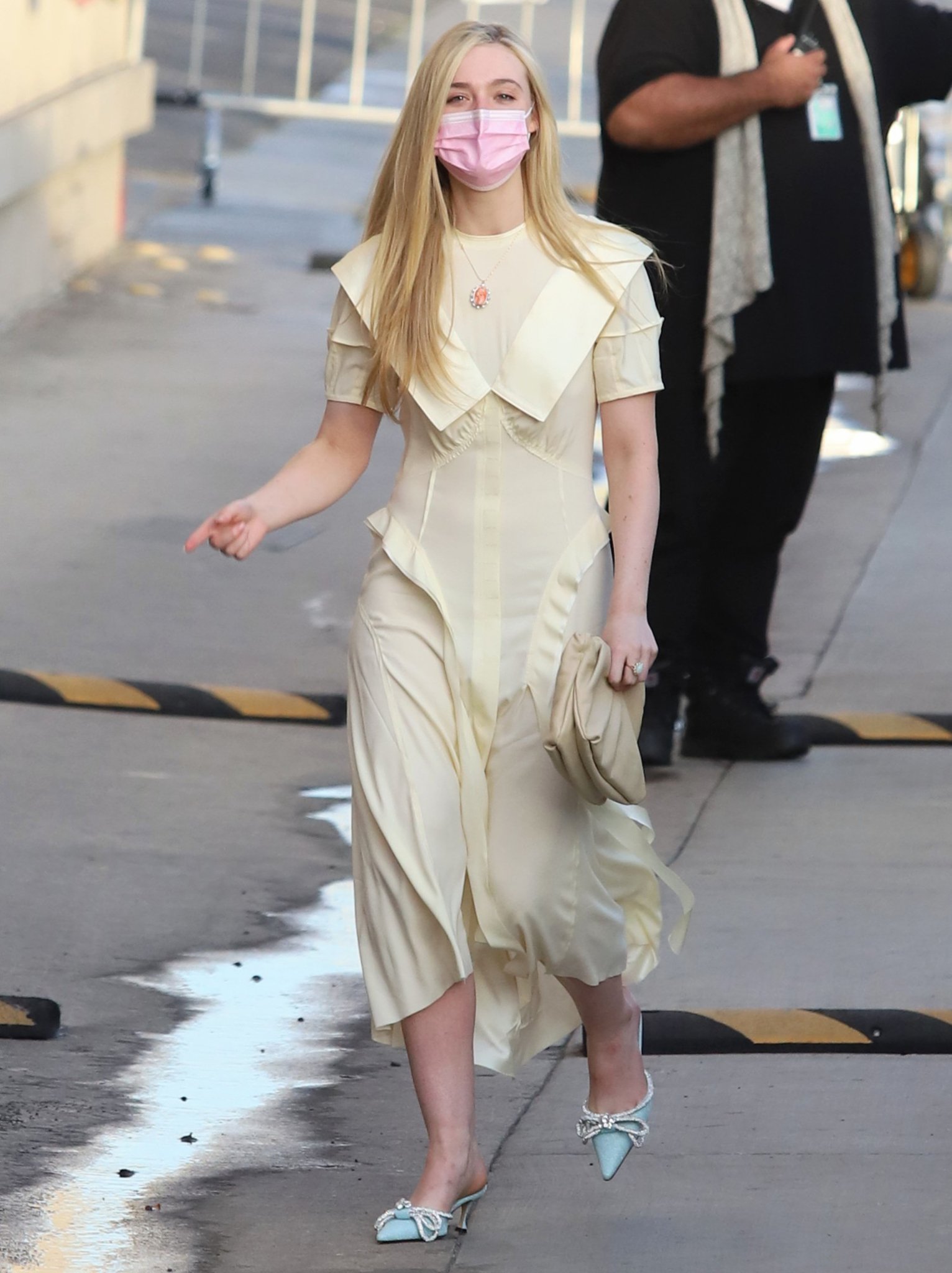 Elle Fanning heads to Jimmy Kimmel Live studio in a conservative yellow dress