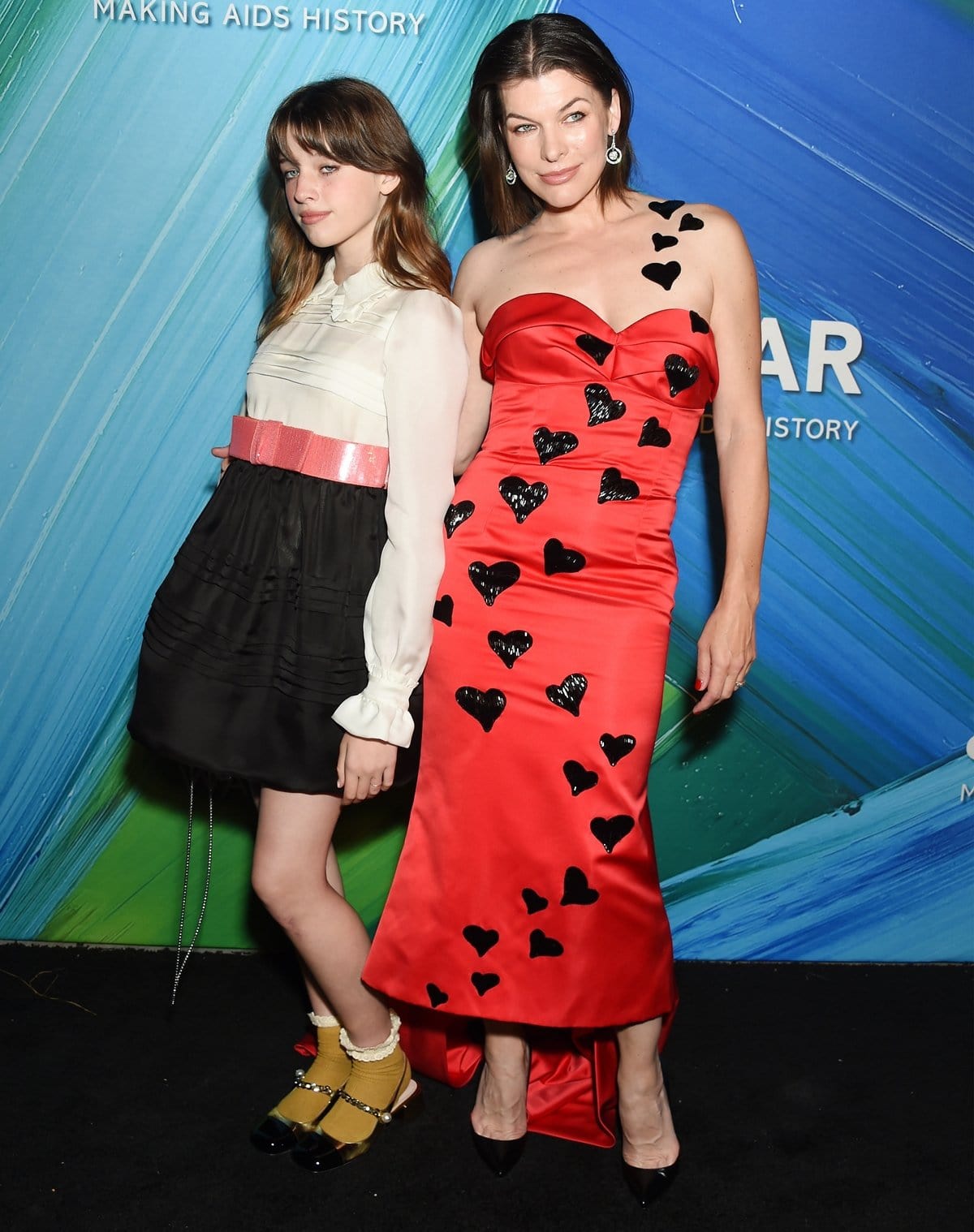 Ever Anderson and her mother Milla Jovovich attend the 2021 amfAR Gala Los Angeles