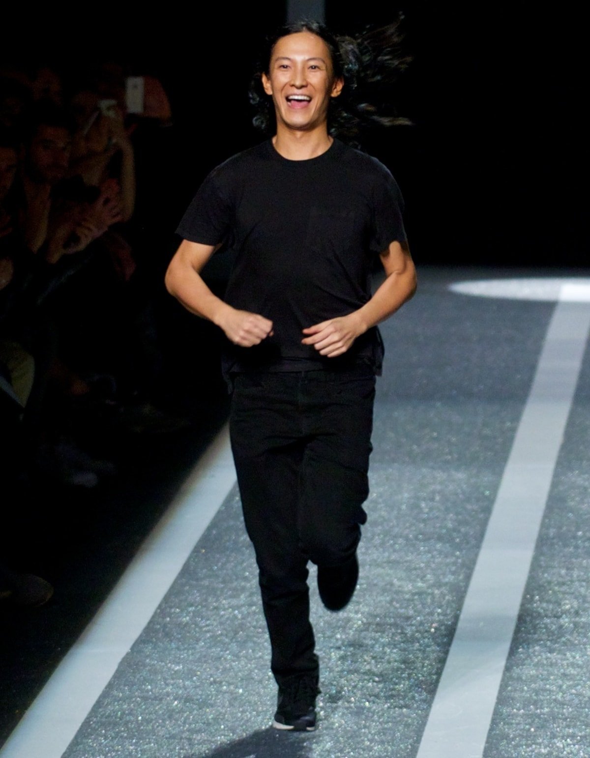 Fashion designer Alexander Wang looking excited on the runway at the Alexander Wang x H&M Collection Launch