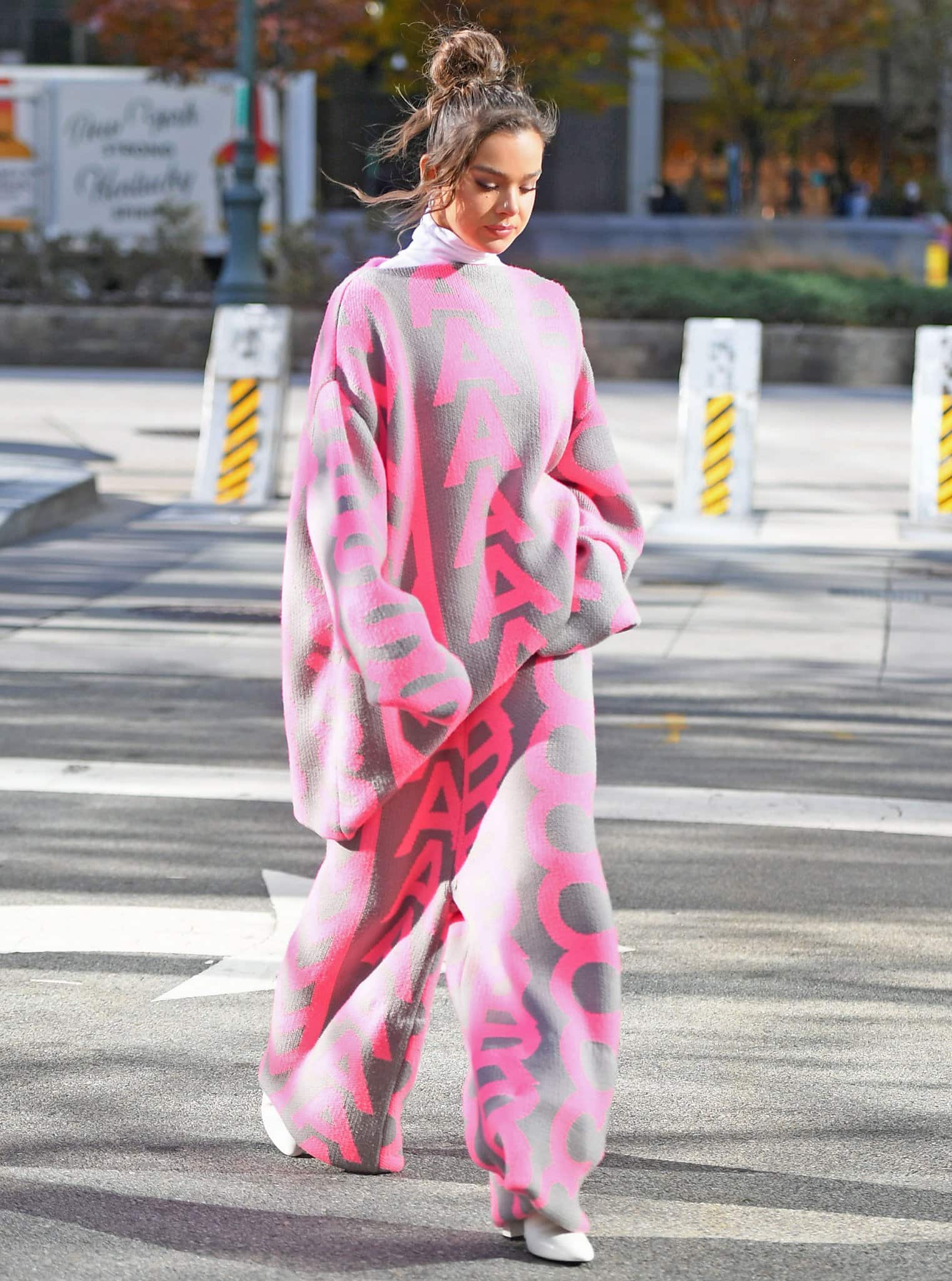 Hailee Steinfeld in a quirky oversized Marc Jacobs pink and gray velour sweater suit while out in New York City on November 23, 2021