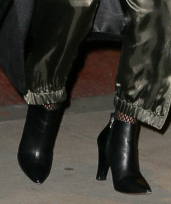 Halle Berry finishes off her quirky date night look with fishnets and pointy ankle boots
