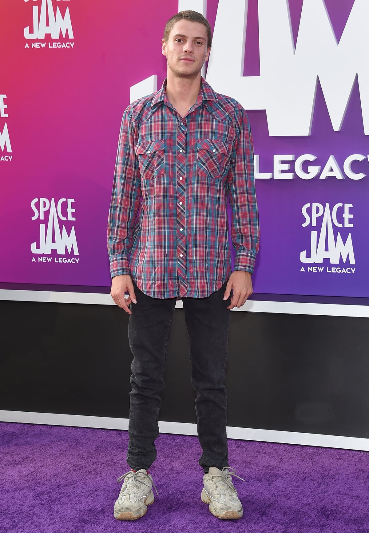 Jace Norman in dirty sneakers paired with black jeans and a plaid shirt at the premiere Of Warner Bros "Space Jam: A New Legacy"