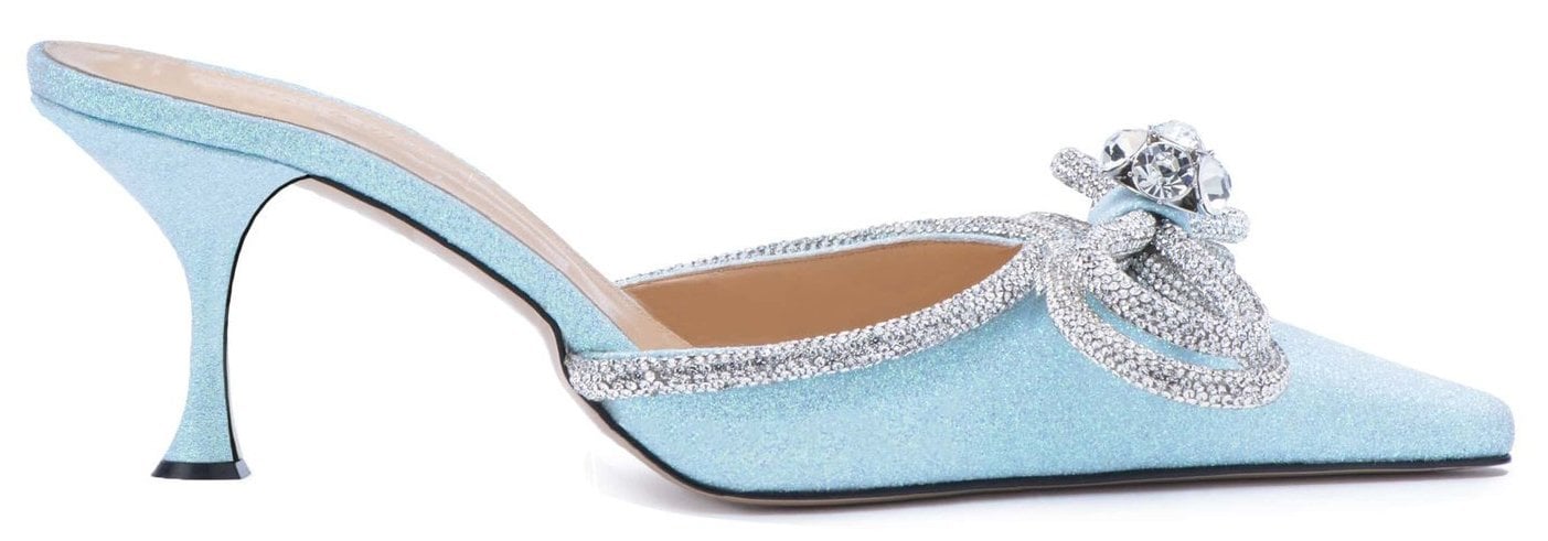 A charming mule made of glittery fabric with crystal-embellished double bows and short kitten heels