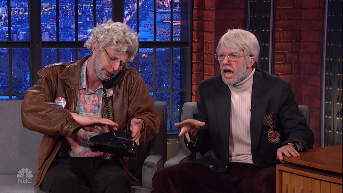 Nick Kroll and John Mulaney in character as The Oh, Hello Show stars Gil Faizon and George St. Geegland during an appearance on NBC's Late Night with Seth Meyers