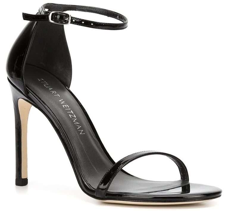 A classic pair of black leather heels with open toes, ankle straps, and stiletto heels