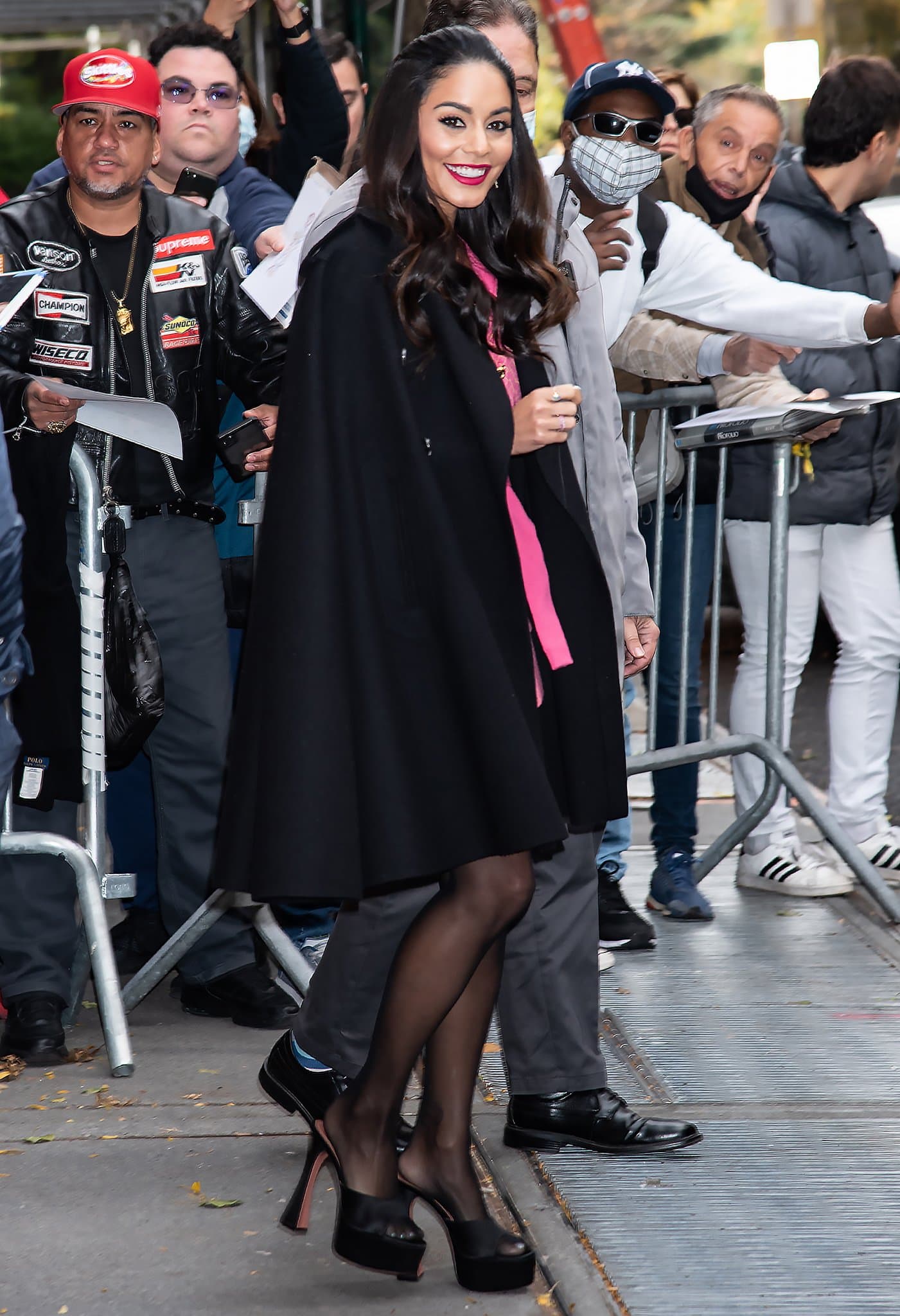 Vanessa Hudgens leaving her Midtown Manhattan hotel in Moschino Resort 2022 pink jacket mini dress and Valentino black cape