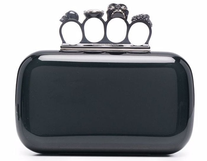 The Skull clutch boasts the label's signature Four Ring knuckle handle with skull charms