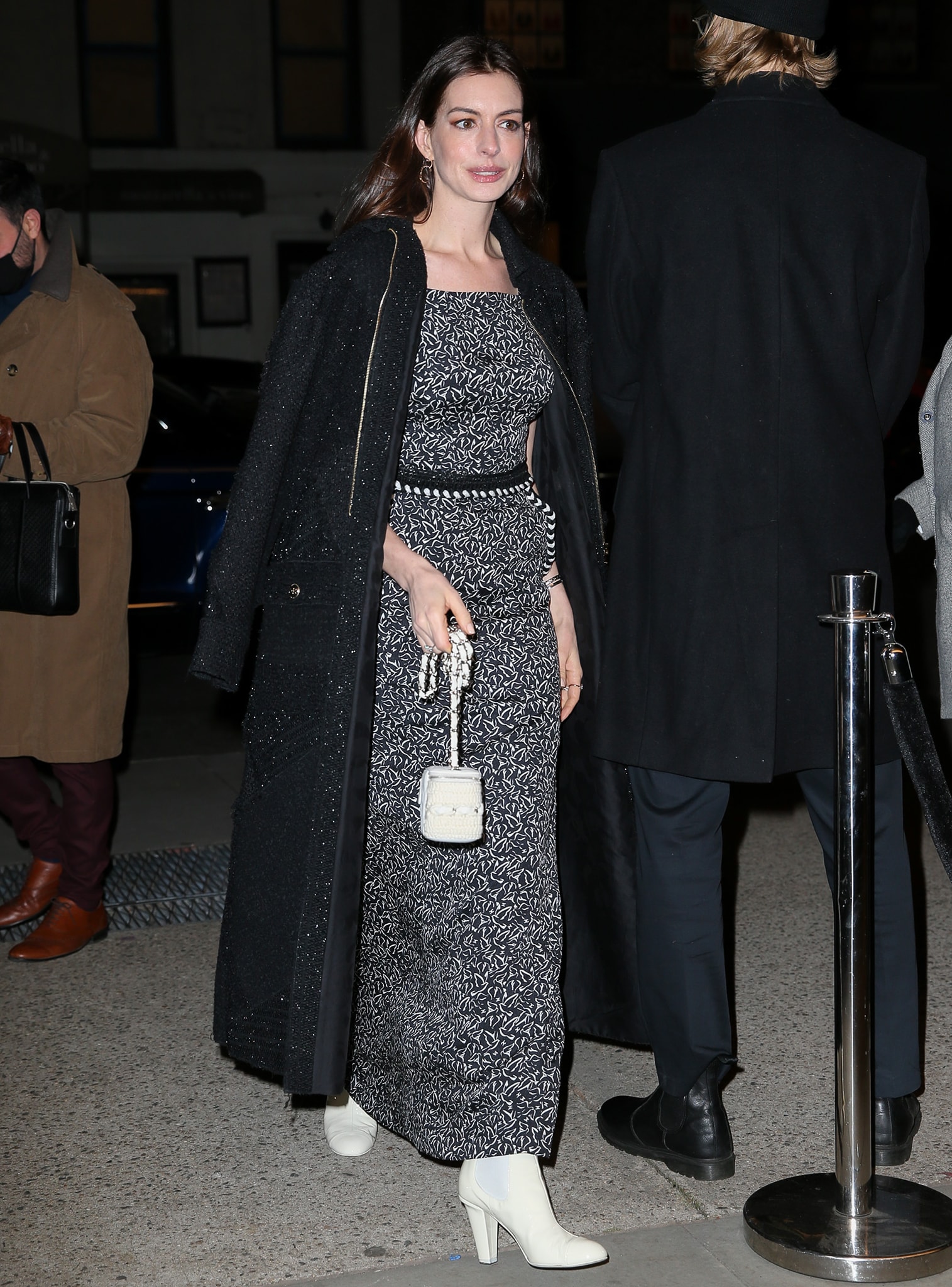 Anne Hathaway looks stylish in Chanel black-and-white patterned maxi dress and tweed coat