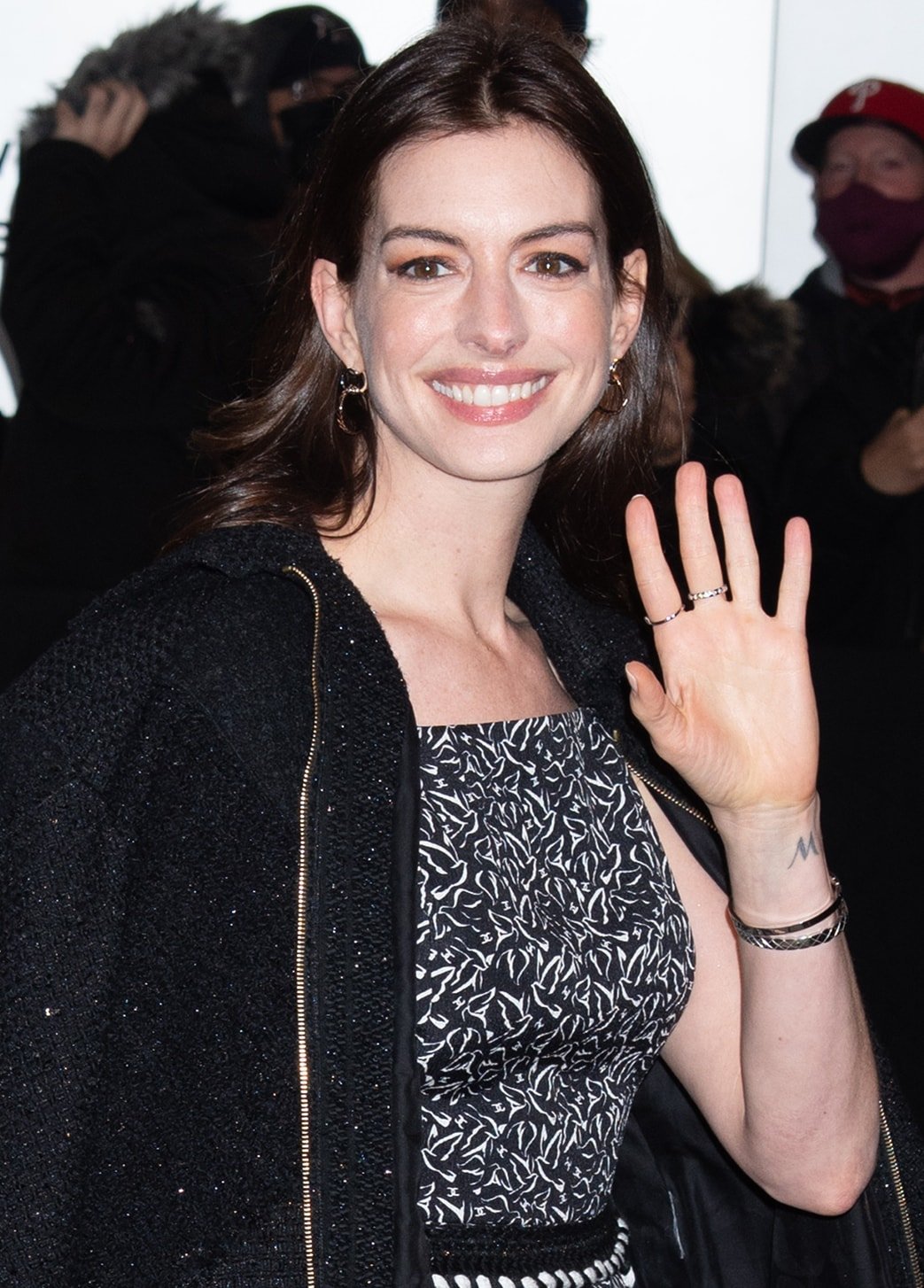 Anne Hathaway highlights her eyes with mascara and eyeshadow and wears her brunette tresses down in natural waves
