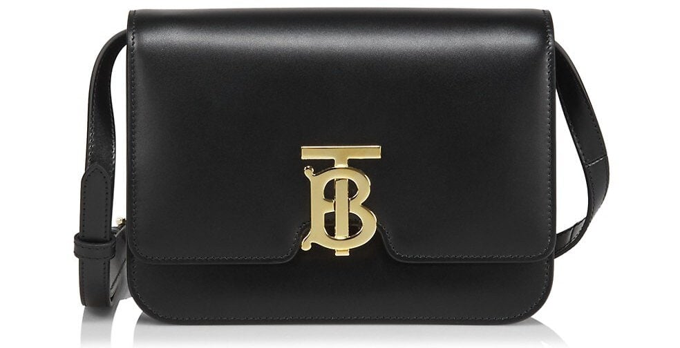 This structured convertible clutch features the iconic Thomas Burberry monogram clasp and a detachable shoulder strap