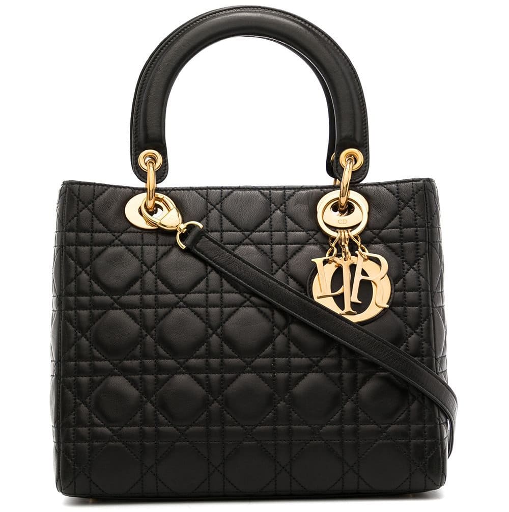 Sleek and refined, the Lady Dior bag is crafted in black lambskin with Cannage quilted stitching, complete with the signature 'D.I.O.R.' charms