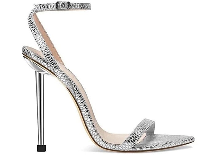 The Femme Ford sandal features snake-effect silver straps and 4.5-inch stiletto heels