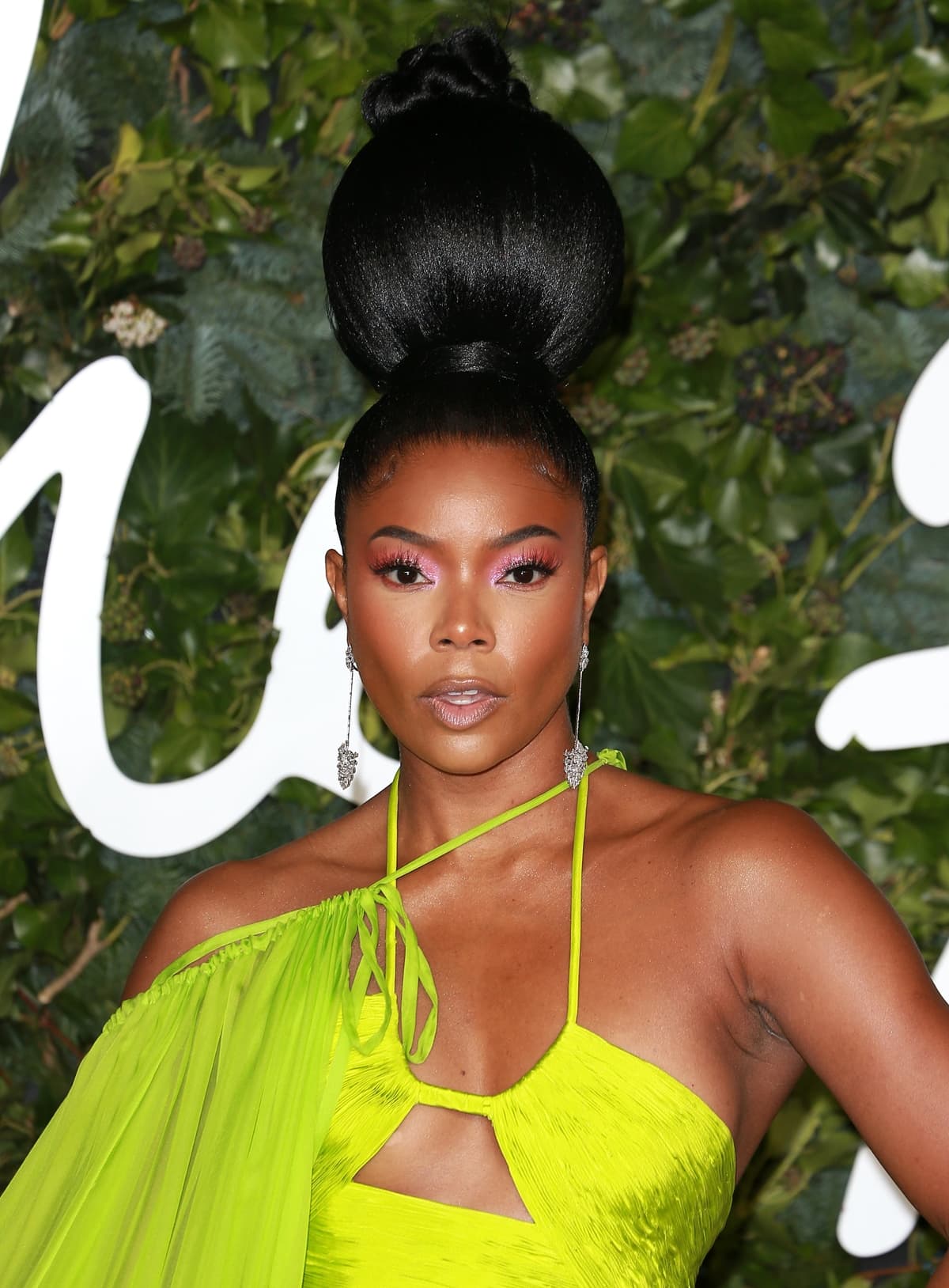 Gabrielle Union wears her hair in an oversized bun with drop earrings by Messika