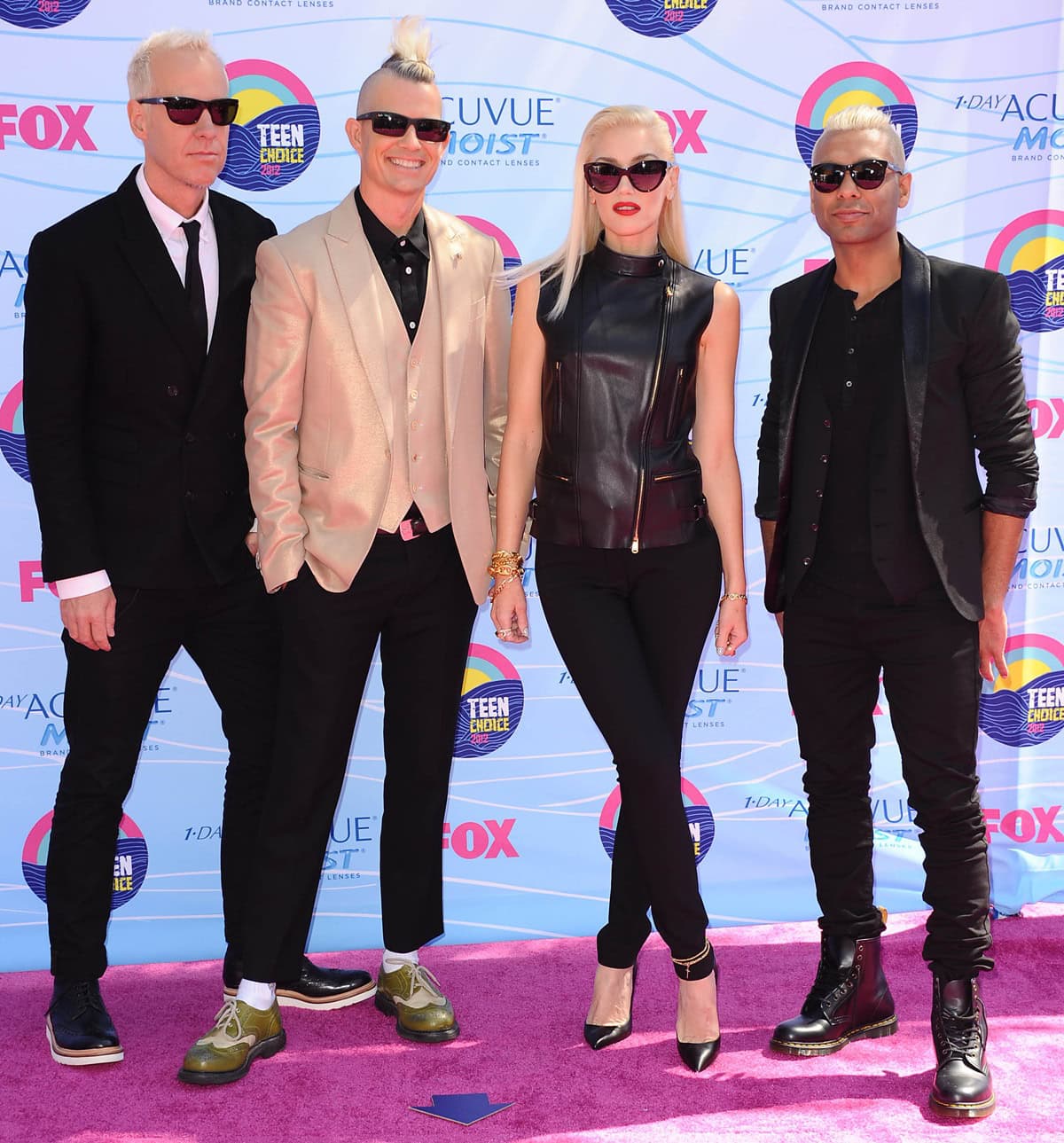 Gwen Stefani stuns in sleek black pointed-toe Christian Louboutin pumps, pairing them with a leather sleeveless top and fitted pants for an edgy-chic red carpet look alongside her No Doubt bandmates